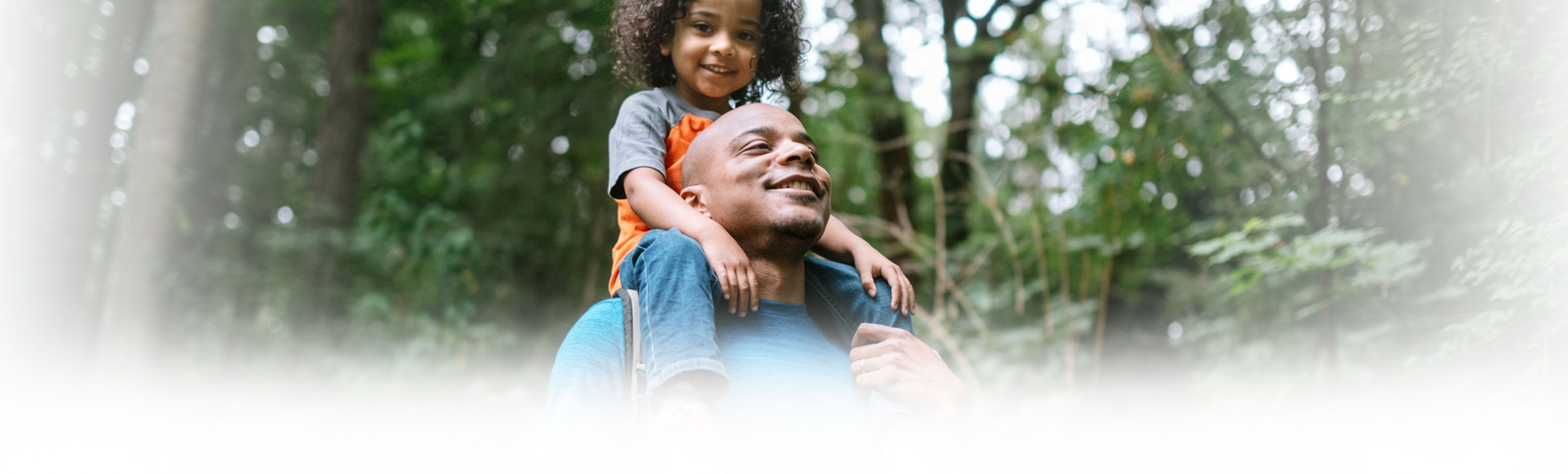 Father carrying son on top of his shoulder